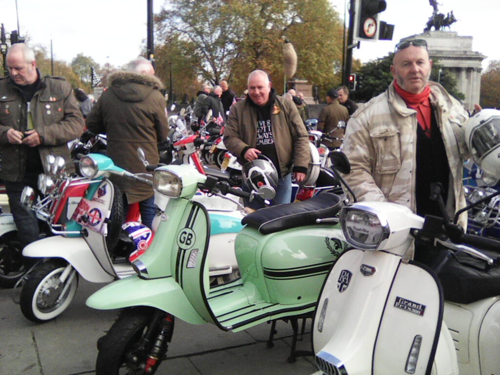 Flags flying as Vespas and Lambrettas head toward Hyde Park.